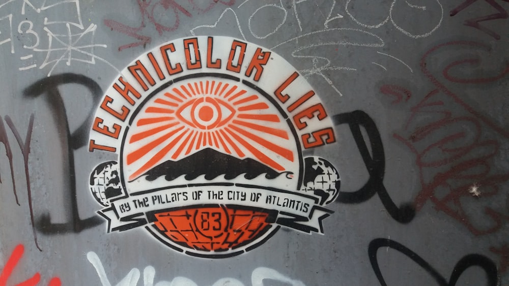 Technicolor Lies logo on gray concrete wall