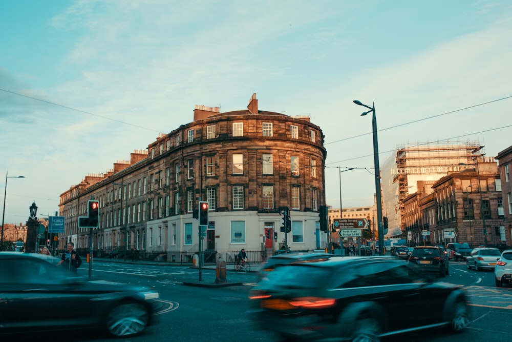 vehicles travelling on road near commercial building time lapse photography during daytime