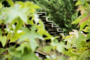 Close-up of detailed wooden garden structures integrated with greenery.