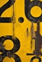 a close up of a yellow and black sign with numbers