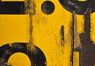 a close up of a yellow and black sign with numbers