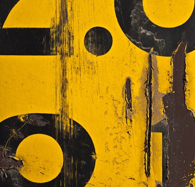 a close up of a yellow and black sign with numbers