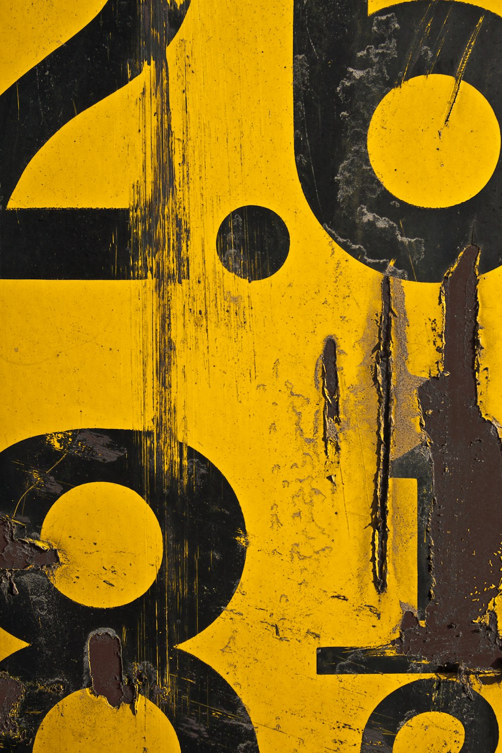 a close up of a yellow and black sign with numbers