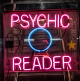 turned on red Psychic Reader neon sign