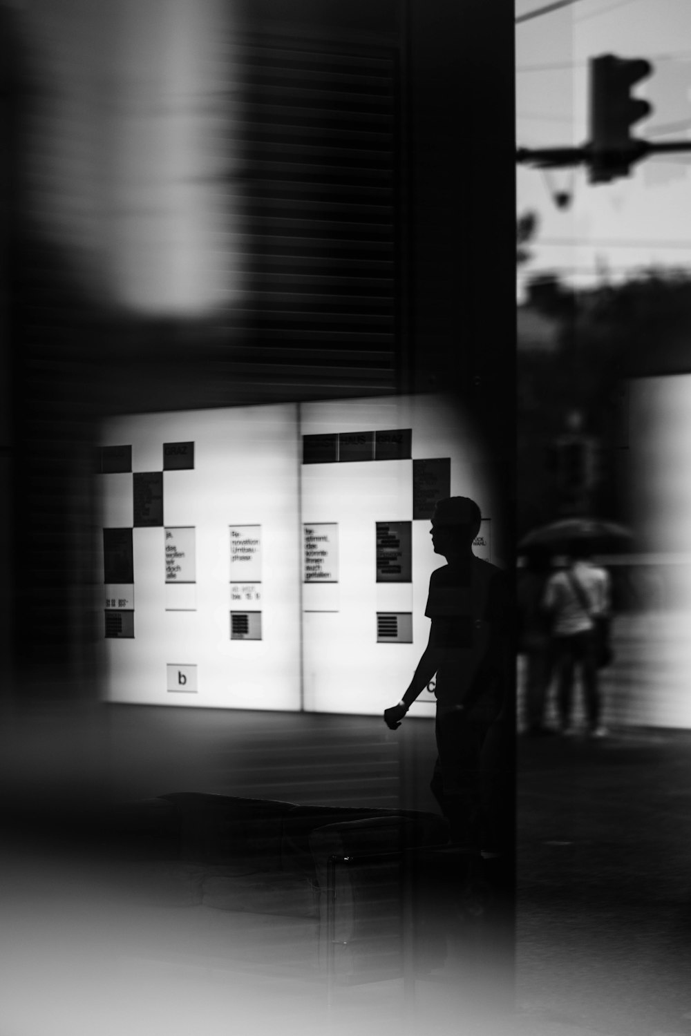 a black and white photo of a person holding an umbrella