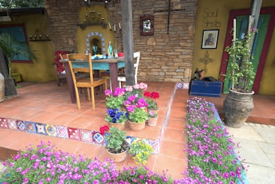 Outdoor patio decorated with hand-crafted tiles showcasing natural motifs.