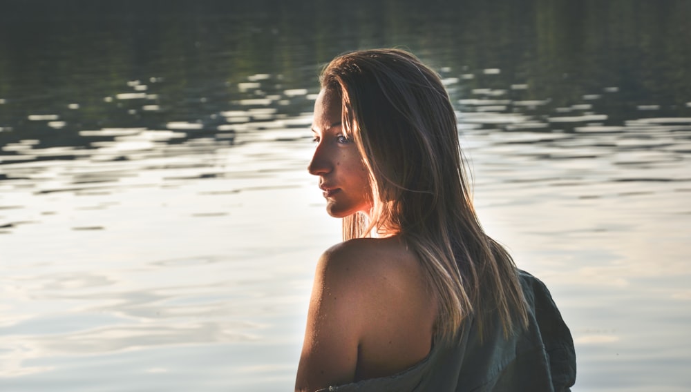 woman with blonde hair on body of water