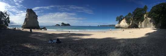 A picturesque beach scene with golden sand and clear turquoise waters.