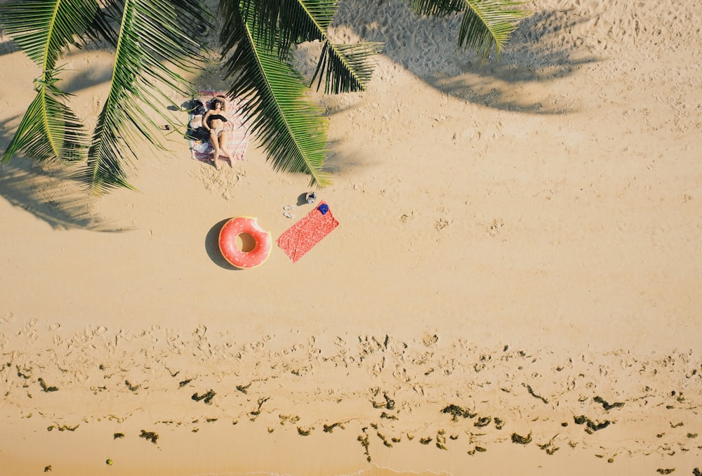 woman lying on shore during daytime