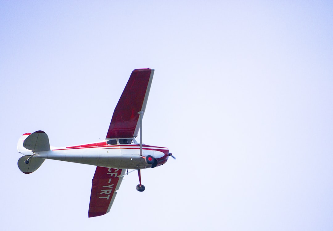 red and white monoplane, Flying through the sky