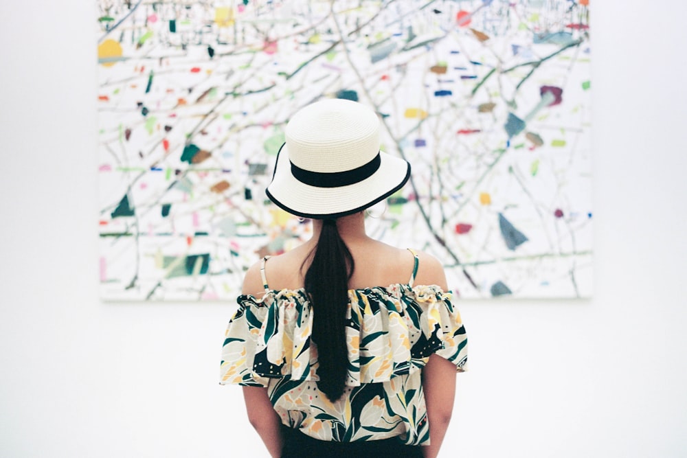 woman standing in front of abstract painting