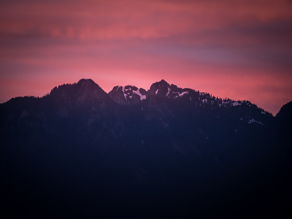 silhouette photo of mountain during sunset