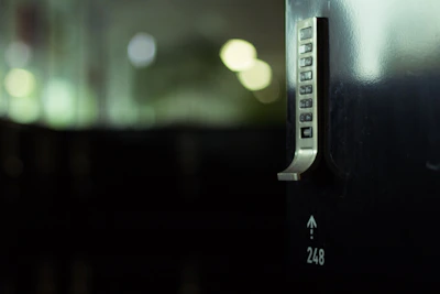 Modern keypad smart lock installed on a contemporary metal door.