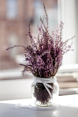 pink petaled flower with clear glass vase centerpiece