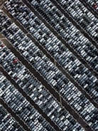 Aerial view of cars parked in a secure lot.