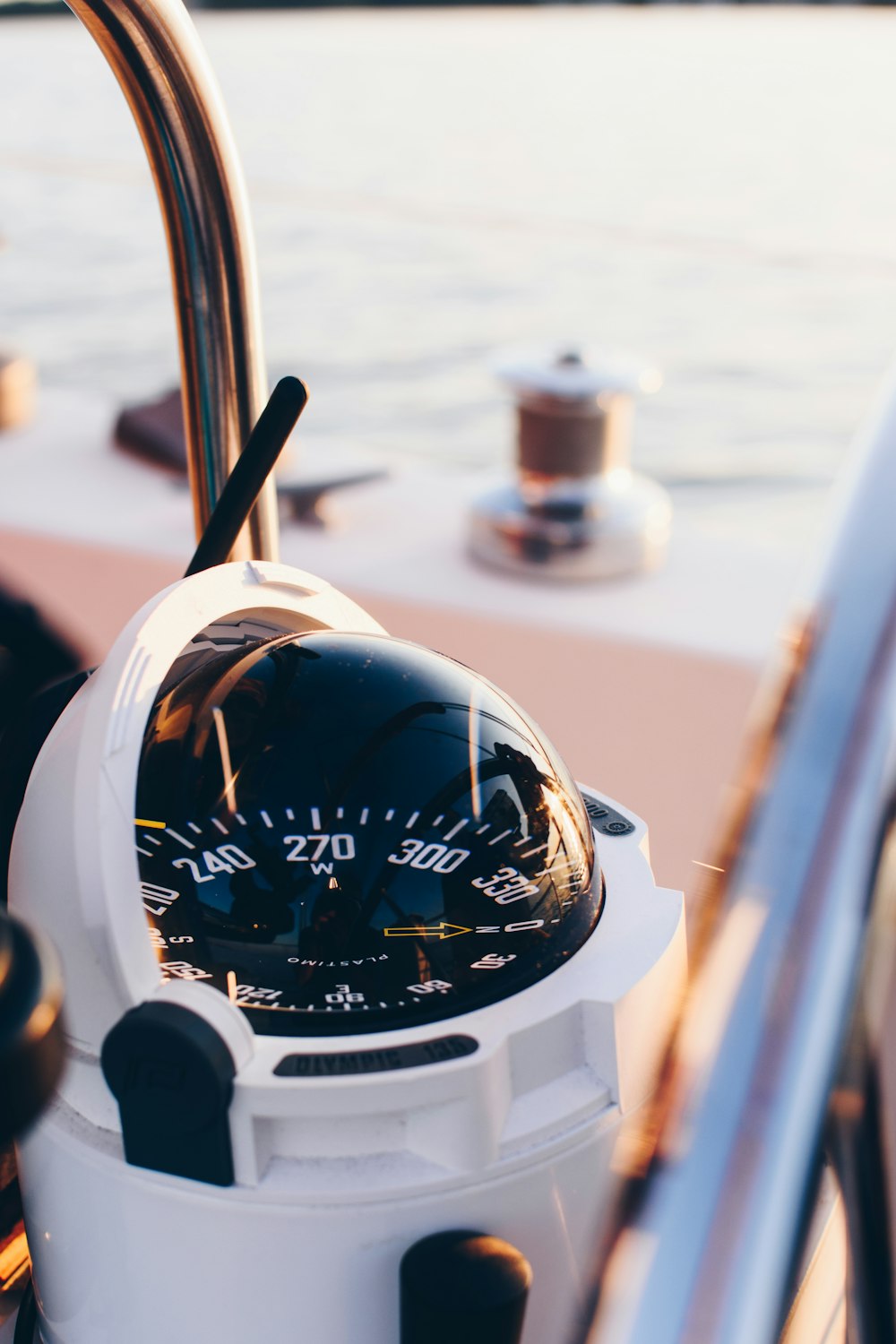 white and black compass pointing at 0 shallow focus photography