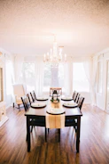 Elegant wooden dining table set in a bright, airy room