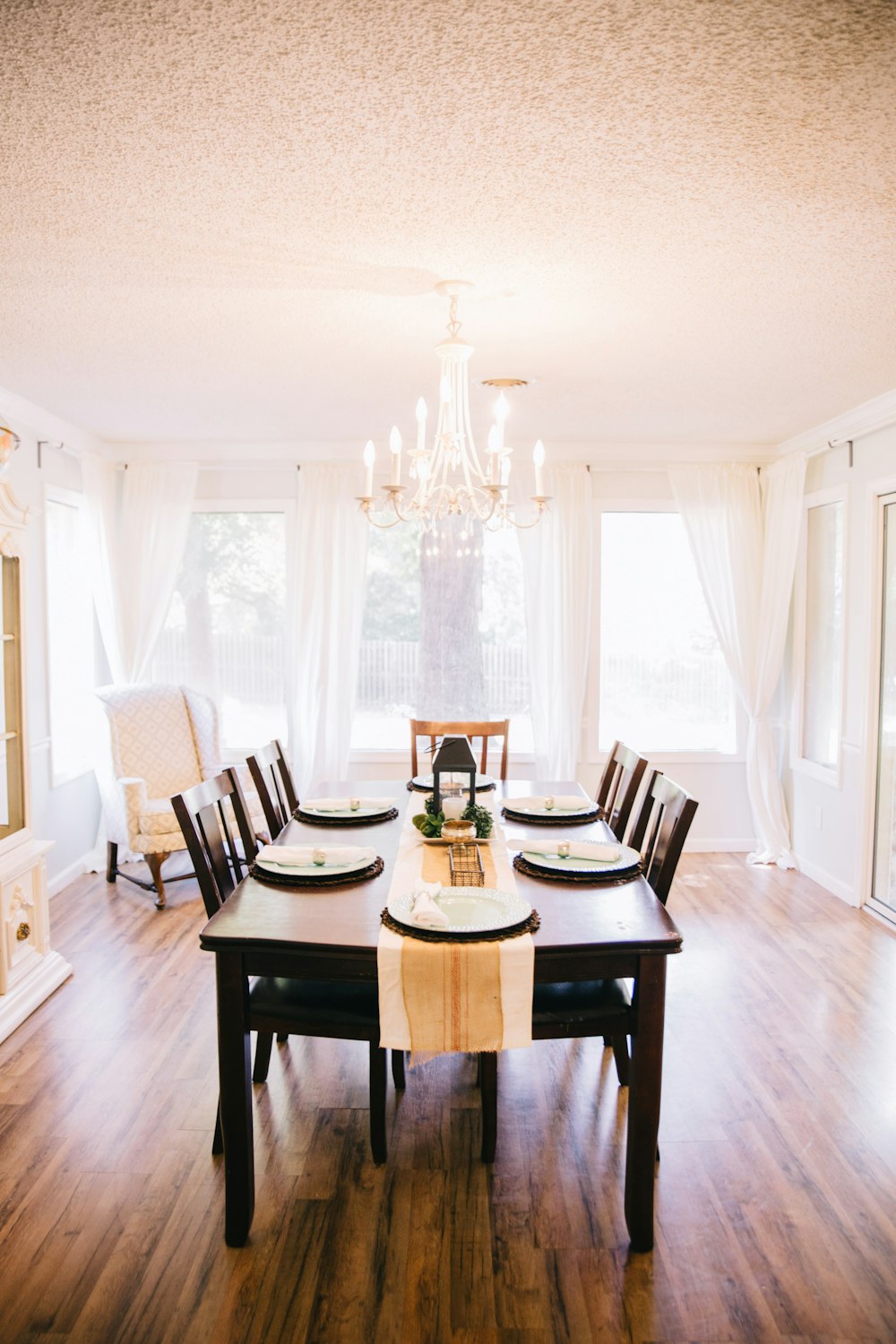 rectangular brown wooden table with tabled near window