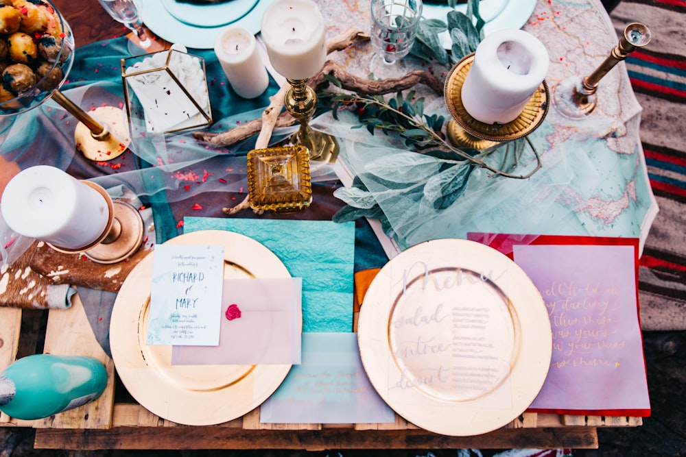 two gold-colored plates on brown wooden table