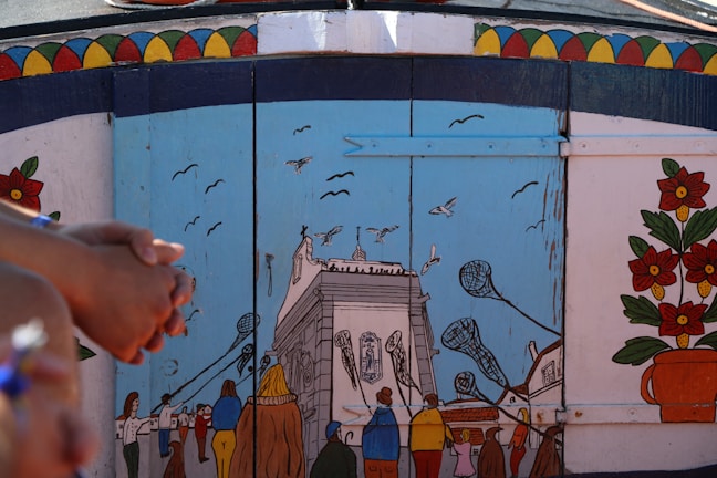 A colorful street mural in Tlalpan depicting local folklore and community life.