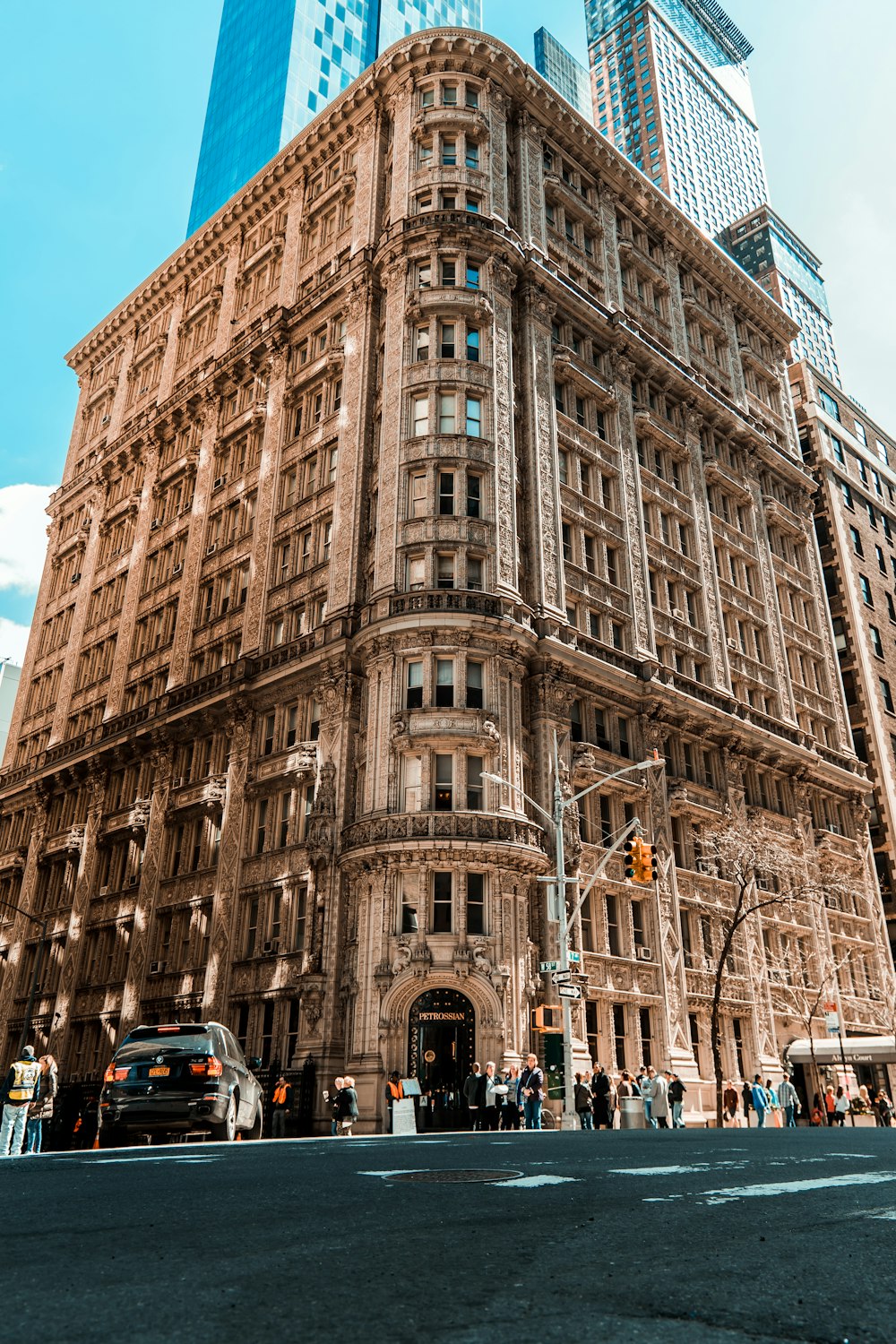 people standing beside high-rise buidling