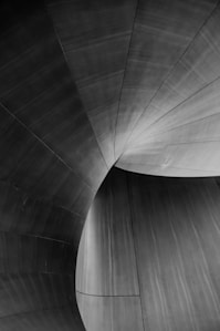 a black and white photo of a curved wall