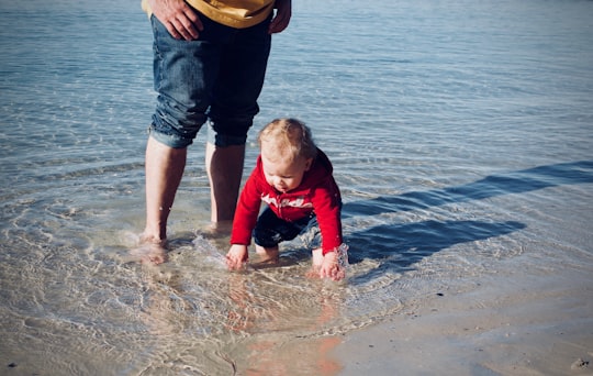 baby standing on body of water in Huskisson Australia