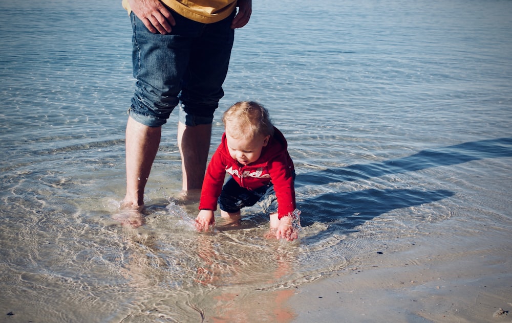 baby standing on body of water