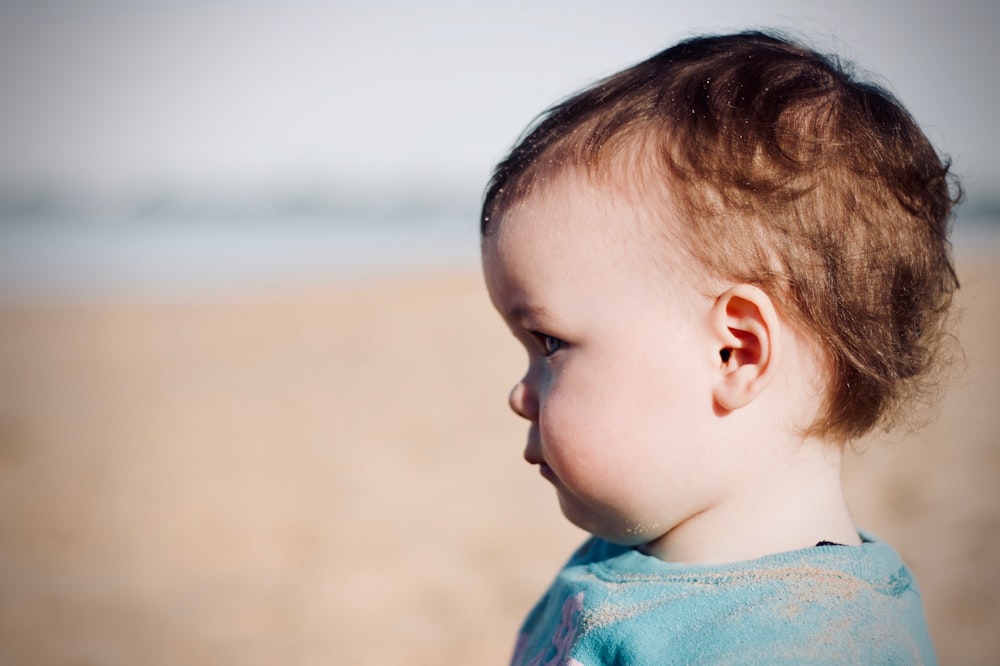 baby standing on beach