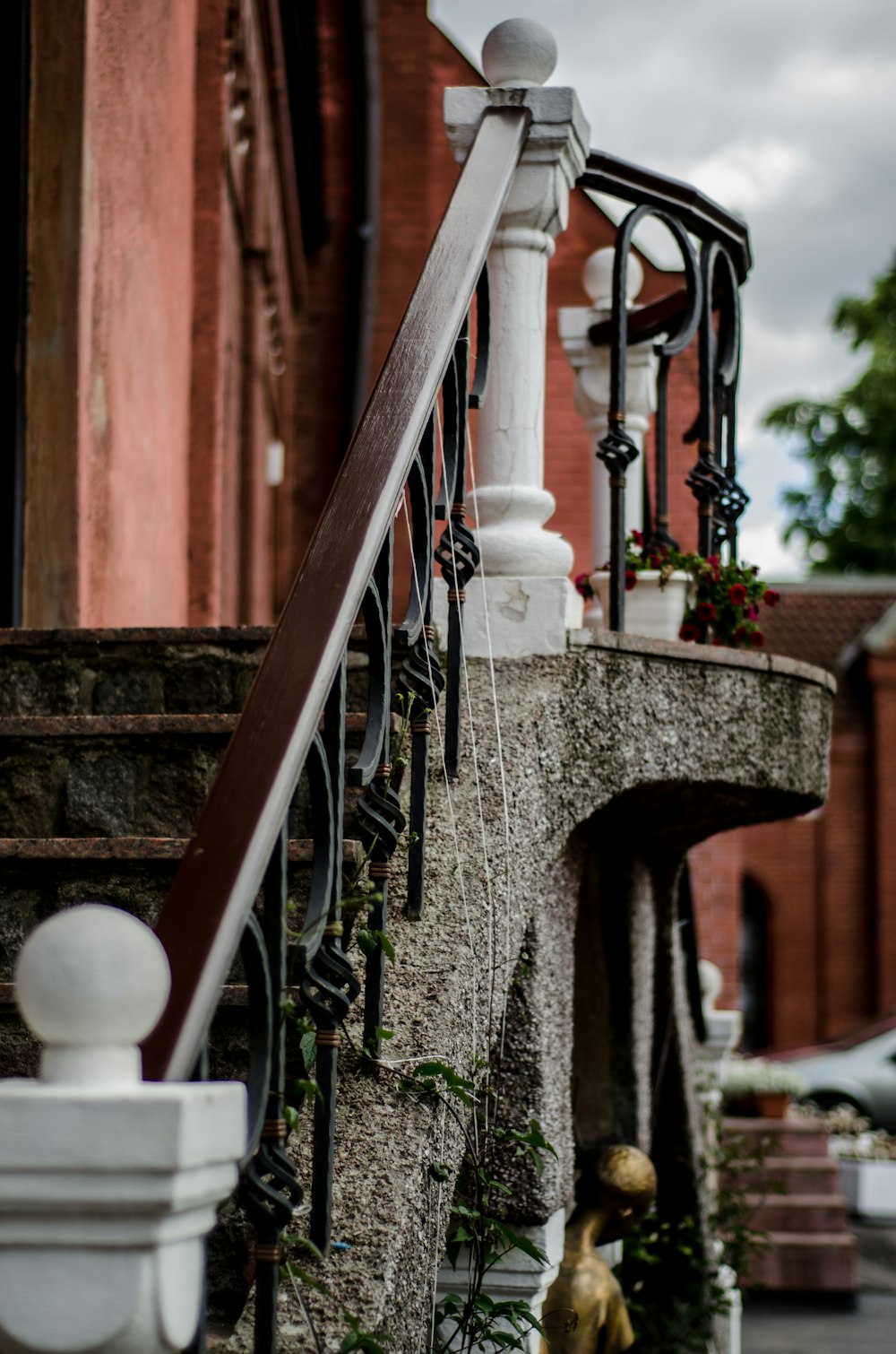 brown and black handrail near brown wall