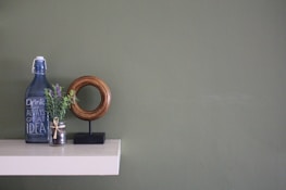 Minimalist shelf displaying eco-friendly jars and bottles in muted colors.