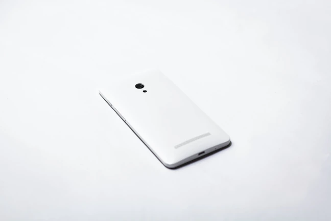 Close-up of a sleek smartphone displayed on a minimalist white surface.
