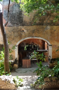 Textured stone wall panels framing a charming outdoor patio.