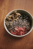 A creamy plant-based protein smoothie bowl topped with nuts, seeds, and fresh berries.
