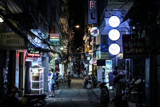 assorted-color concrete stores at night in Hanoi Vietnam