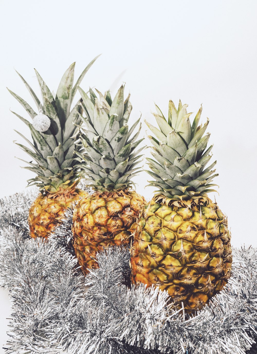 three yellow pineapple fruits