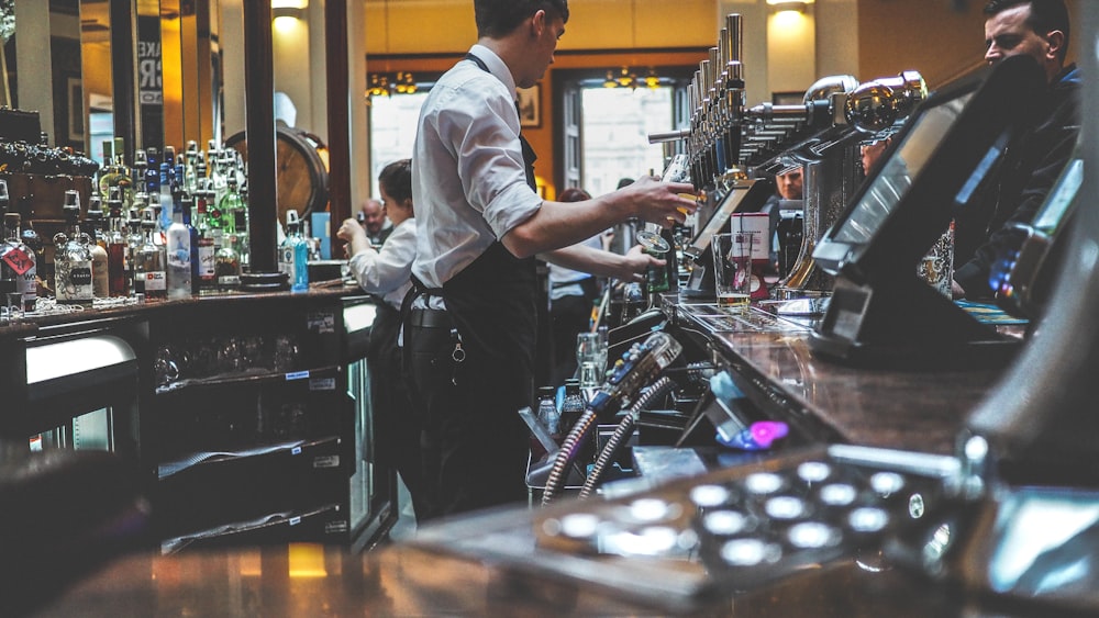 man preparing beverage drink in bar