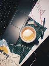 A serene workspace with a laptop, notepad, and a cup of tea, symbolizing creativity.
