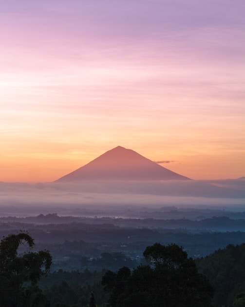 mountain under orange sky