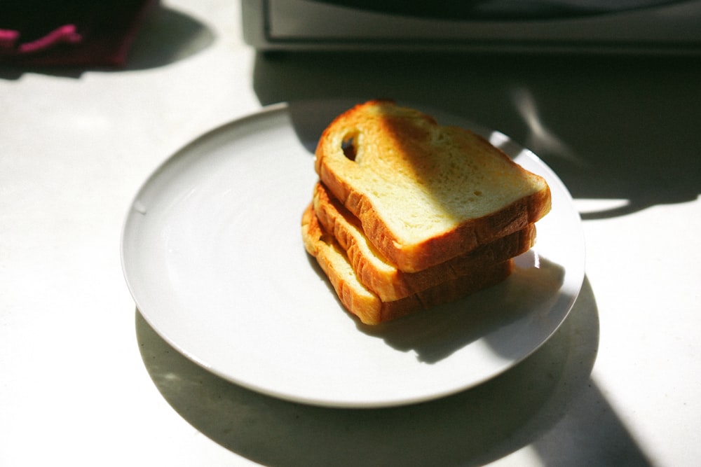 three sliced breads on white ceramic plate