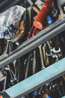 A rugged lockable tool chest with drawers open, showcasing neatly stored wrenches and screwdrivers.