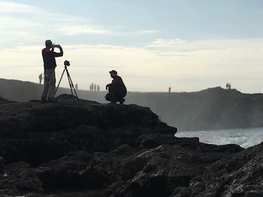 Behind-the-scenes view of the artist setting up a camera on Ireland’s coast.