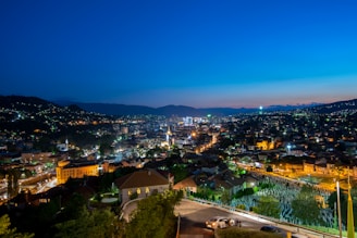 A vibrant cityscape at dusk with our comfortable vehicle parked nearby