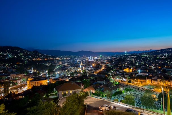 A vibrant cityscape at dusk with our comfortable vehicle parked nearby