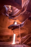 Sunlight beams piercing through narrow sandstone walls inside Antelope Canyon.
