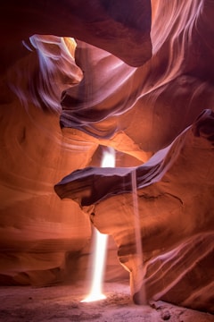 Sunlight beams piercing through narrow sandstone walls inside Antelope Canyon.