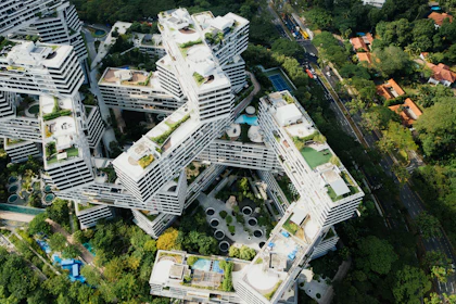 Aerial view of a low-rise residential quarter set into dense forest