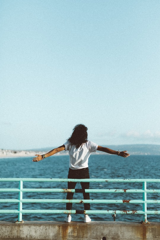 woman standing in front of sea under clear blue sky in Manhattan Beach United States