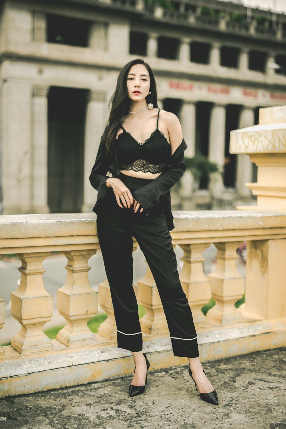 woman standing near brown concrete railing during daytime