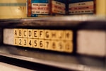 selective focus photo of alphabet and latter tile